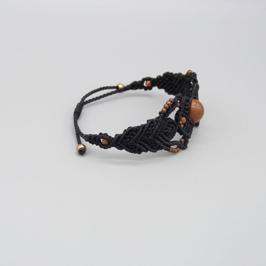 Zwarte micro-macramé armband met een centrale "sunstone" kraal