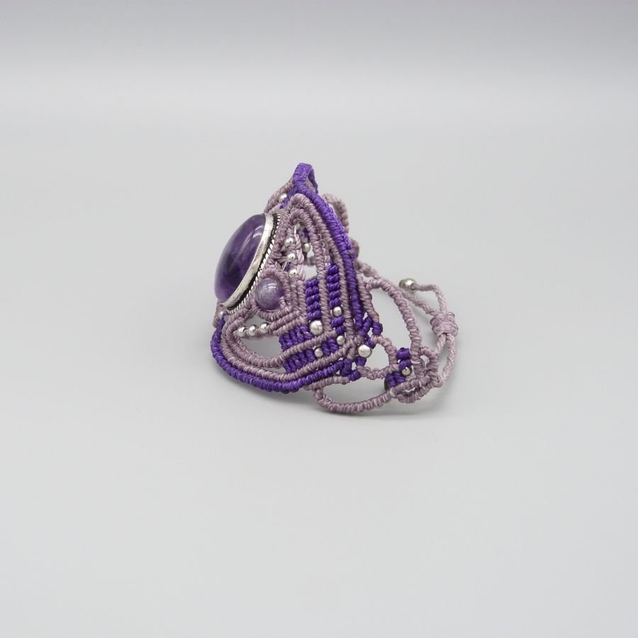 Paarse micro-macramé armband met een amethist gezet in het midden