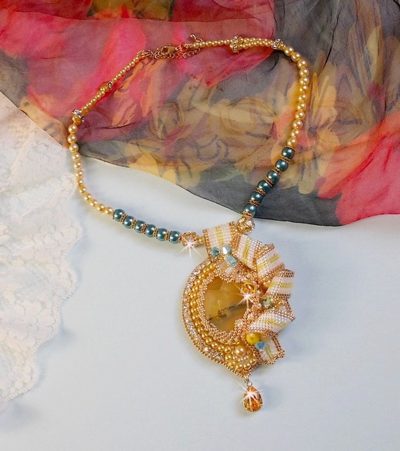 Haute-Couture Sunflower Gold hanger geborduurd met 24 karaats vergulde rocailles, een Madagaskar opaal en Swarovski kristallen.