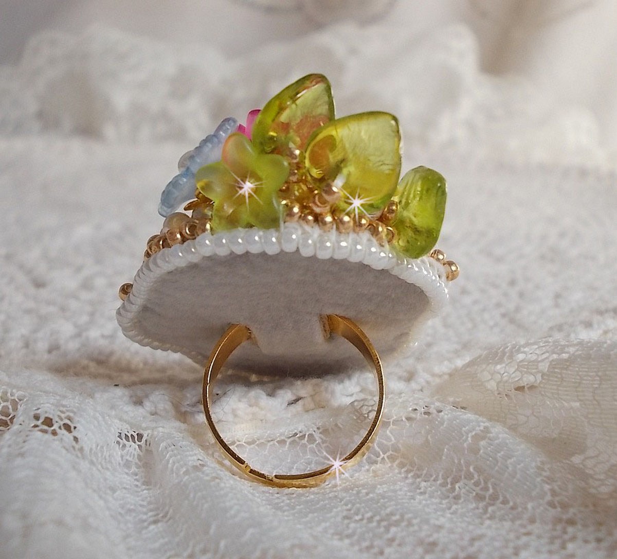 Envolée Fleurie ring geborduurd met een hars cabochon van Lucite bloemen, parels en rocailles.