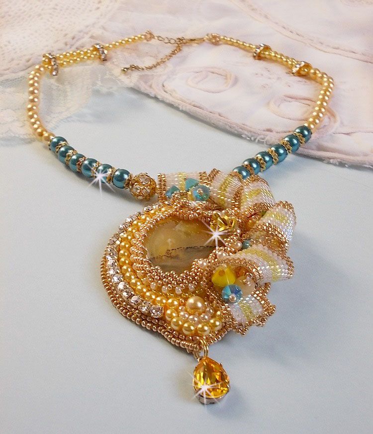 Haute-Couture Sunflower Gold hanger geborduurd met 24 karaats vergulde rocailles, een Madagaskar opaal en Swarovski kristallen.