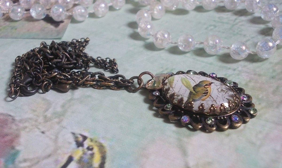 Tuinvogel ketting gemaakt met een braam cabochon en kristallen gemonteerd op bronzen accessoires
