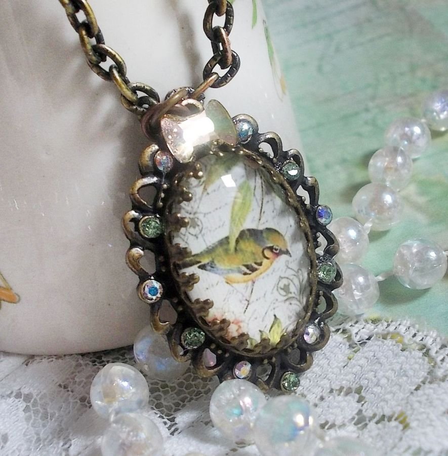 Tuinvogel ketting gemaakt met een braam cabochon en kristallen gemonteerd op bronzen accessoires