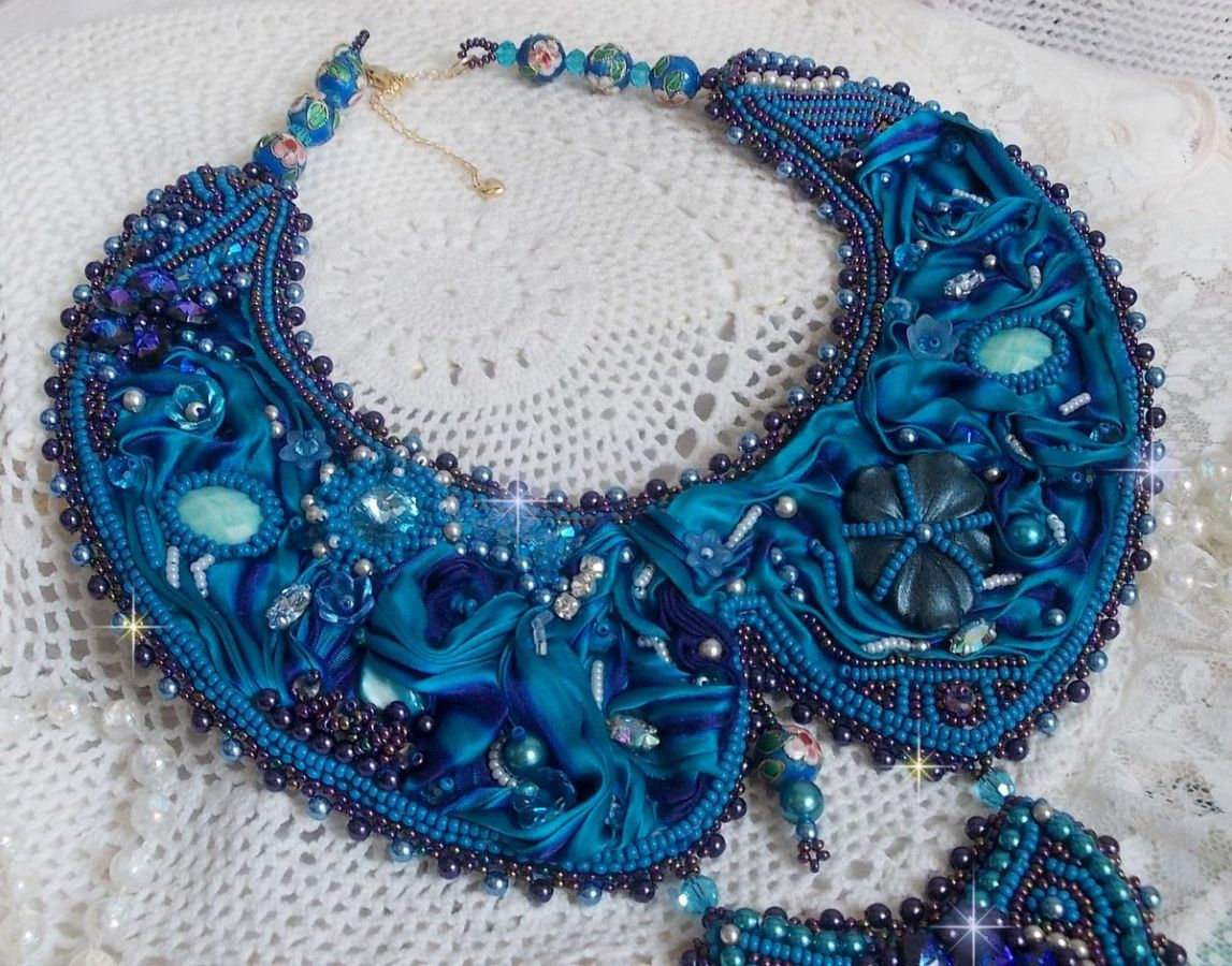 Royal Blue Haute-Couture slabbetjesketting geborduurd met een paars en eend blauw zijden lint, kristallen en diverse kralen. 