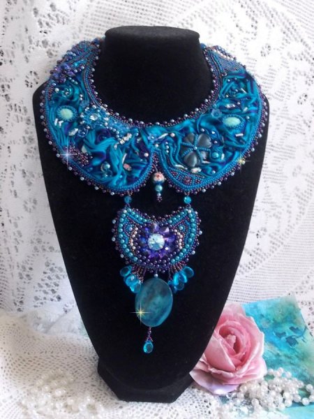 Royal Blue Haute-Couture slabbetjesketting geborduurd met een paars en eend blauw zijden lint, kristallen en diverse kralen. 