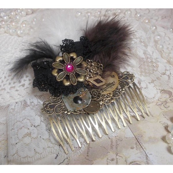 Curiosity Time haarkam gemaakt met zwart kant, diverse accessoires, gouden, zilveren en bronzen bedels met zwarte, bruine en witte veren.